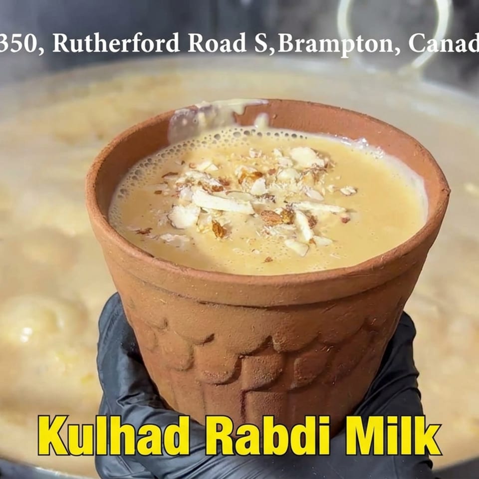 Kulhad rabdi milk topped with chopped nuts, served in a traditional clay cup at Real Fruit Desserts Cafe.